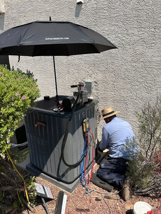 HVAC technician performing outdoor AC maintenance in Boonville